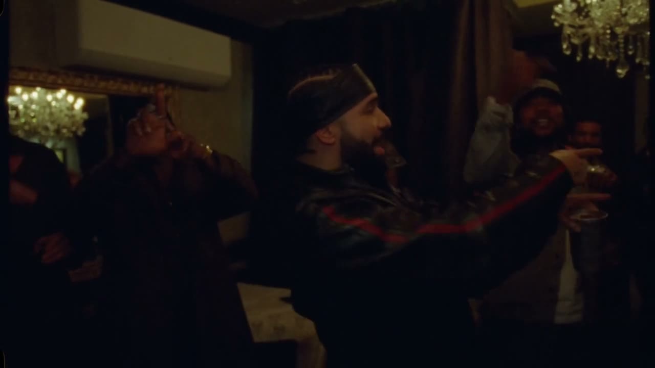 Source frame of the lead pointing while other people remain in the warm room
