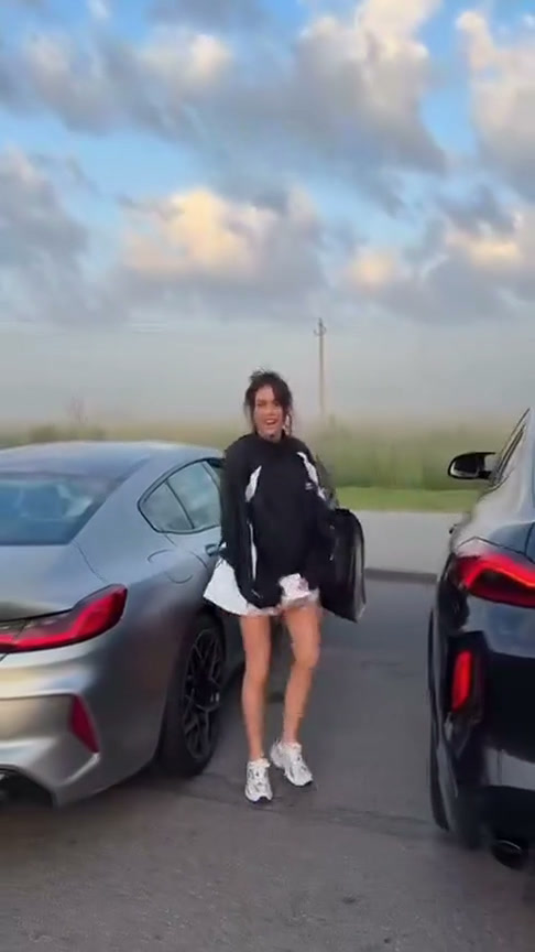 Source frame of the car-side performer leaning at an open door